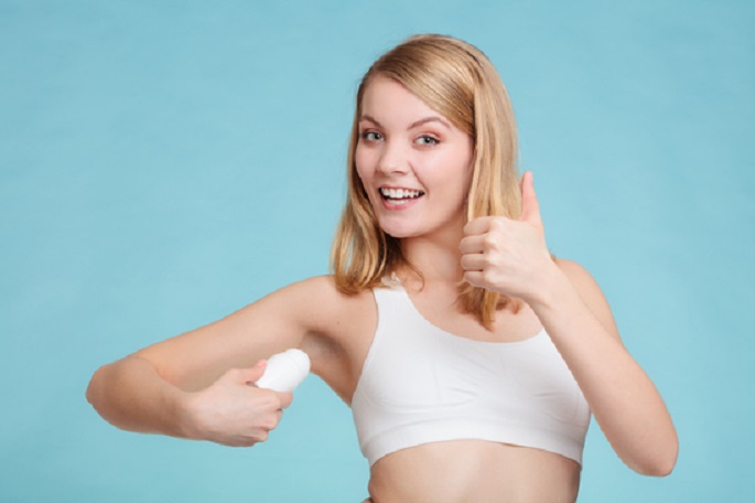 Picture of a woman applying hypoallergenic deodorant under her arms